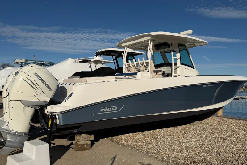 Slide: The Image of 2017 Boston Whaler 350 Outrage boat on display at marina under clear blue sky. - 36