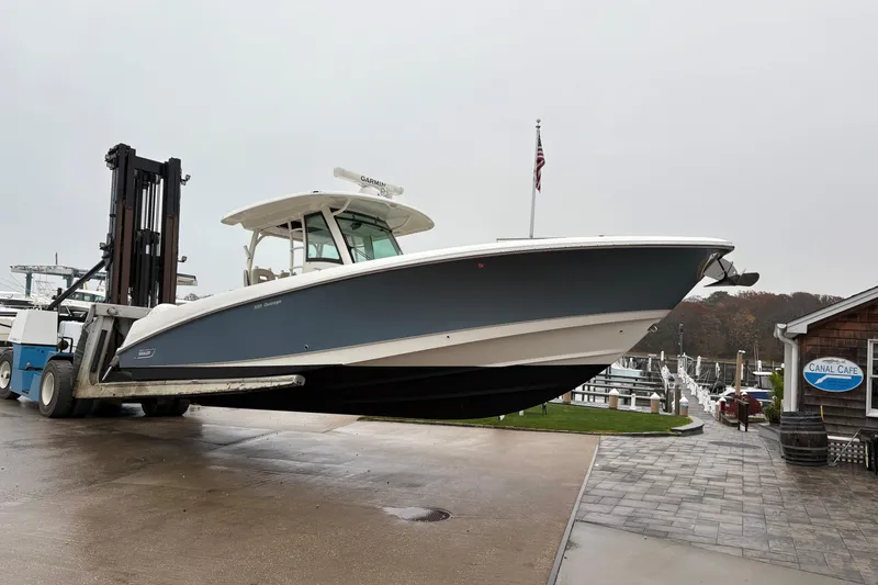 Slide: The Image of 2017 Boston Whaler 350 Outrage boat on forklift at marina. - 40