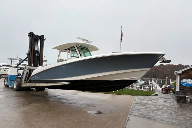 Slide: The Image of 2017 Boston Whaler 350 Outrage on forklift near marina and Canal Cafe. - 41