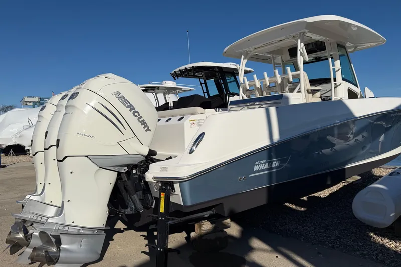 Slide: The Image of 2017 Boston Whaler 350 Outrage with twin Mercury engines, docked outdoors. - 5