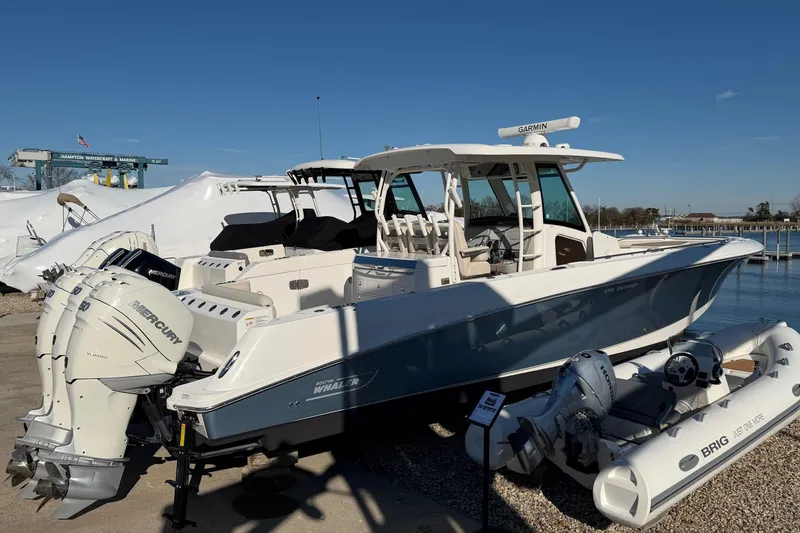 Slide: The Image of 2017 Boston Whaler 350 Outrage boat with Mercury engines, docked near water. - 6