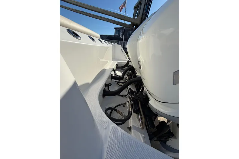 Slide: The Image of 2017 Boston Whaler 350 Outrage boat engine detail with American flag in background. - 7
