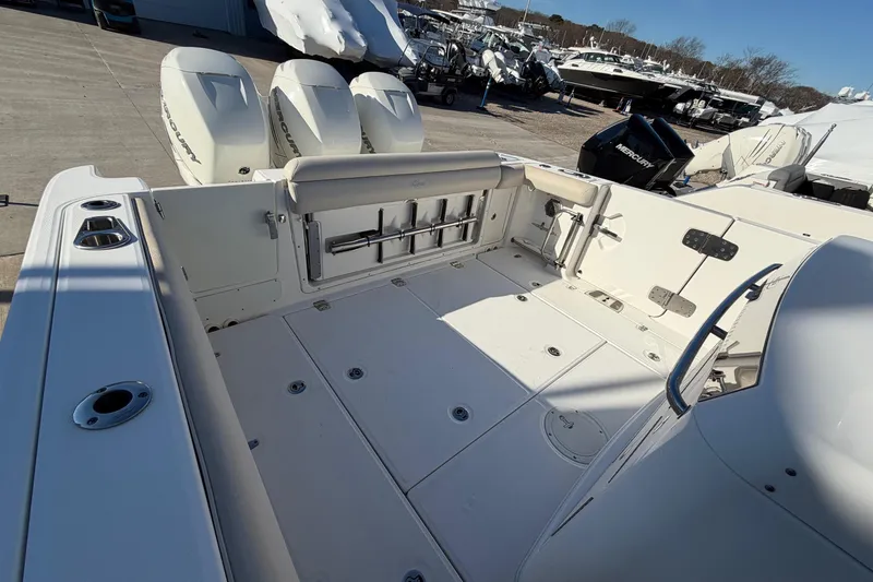 Slide: The Image of 2017 Boston Whaler 350 Outrage boat deck with triple Mercury engines. - 9
