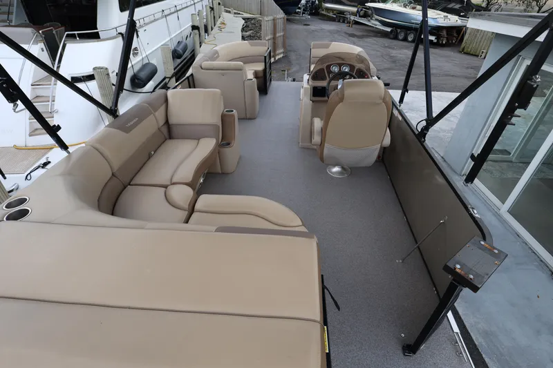 Slide: The Image of 2019 Veranda 22 VR pontoon boat interior with beige seating and steering console. - 10