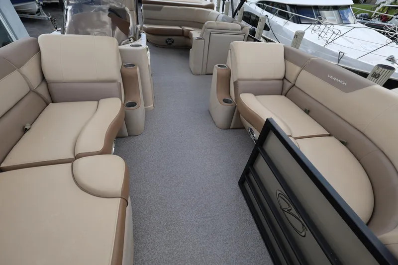 Slide: The Image of 2019 Veranda 22 VR pontoon boat interior with beige seating and spacious layout. - 14