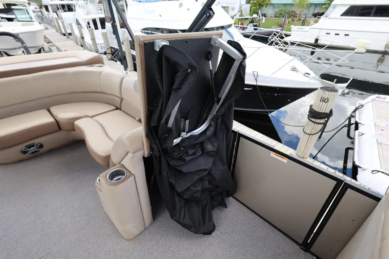 Slide: The Image of 2019 Veranda 22 VR boat interior with beige seating and storage compartment. - 16