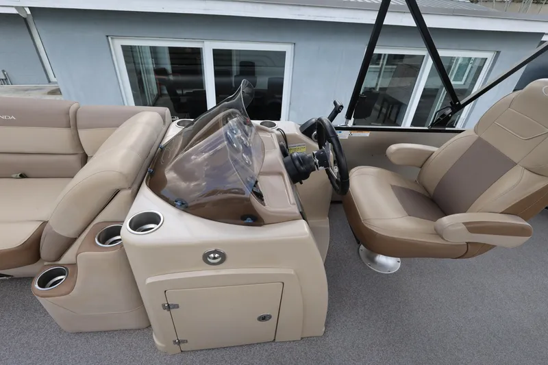 Slide: The Image of 2019 Veranda 22 VR boat interior with beige seating and steering console. - 17