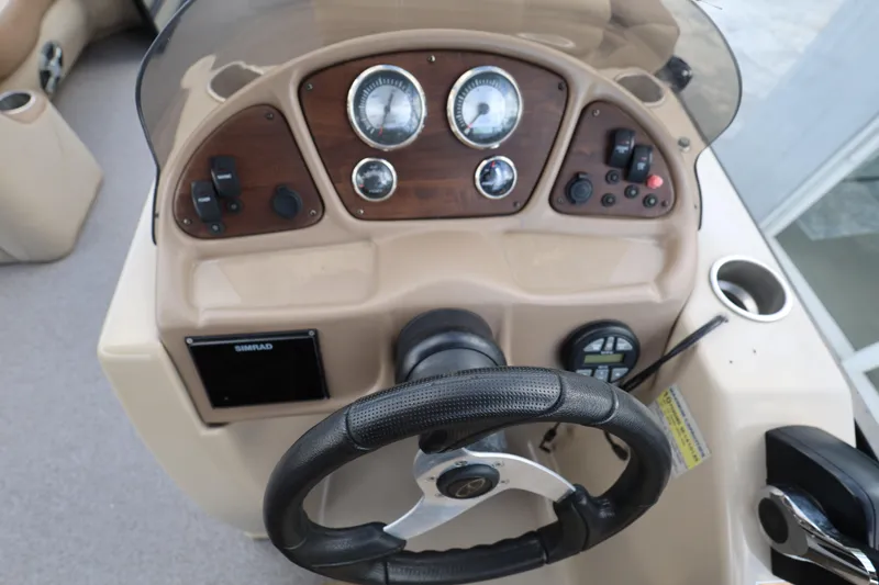 Slide: The Image of 2019 Veranda 22 VR boat dashboard with steering wheel and control panel. - 19