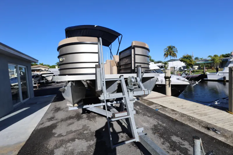 Slide: The Image of 2019 Veranda 22 VR pontoon boat on trailer, dockside view, sunny day. - 2