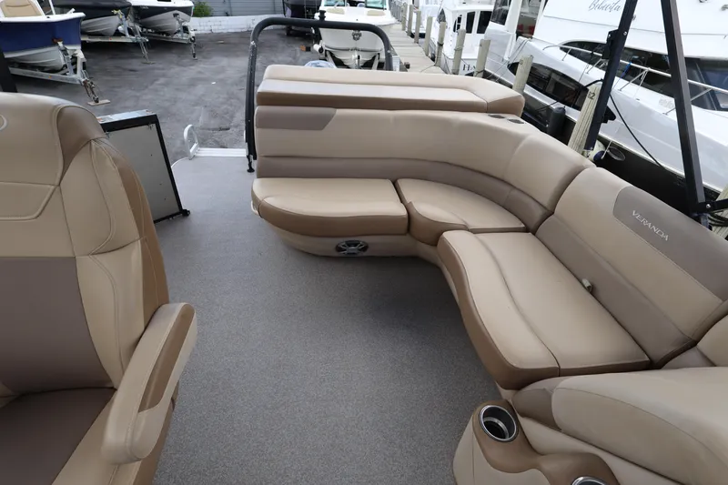 Slide: The Image of 2019 Veranda 22 VR boat interior with beige seating and cup holders. - 21