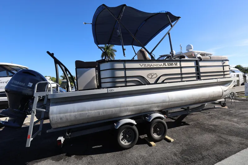 Slide: The Image of 2019 Veranda 22 VR pontoon boat on trailer with Yamaha motor, parked outdoors. - 3
