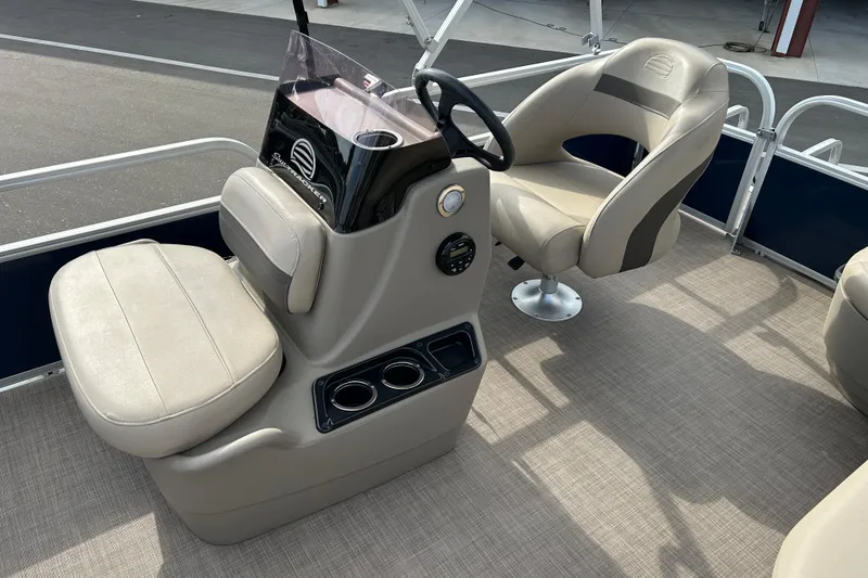 Slide: The Image of 2021 Sun Tracker Bass Buggy 16 XL interior with beige seating and steering console. - 10