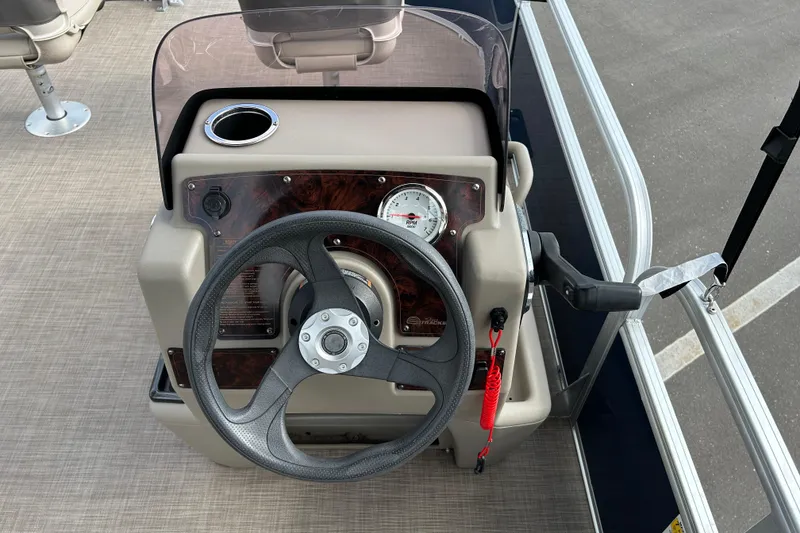 Slide: The Image of 2021 Sun Tracker Bass Buggy 16 XL steering console with RPM gauge and cup holder. - 12
