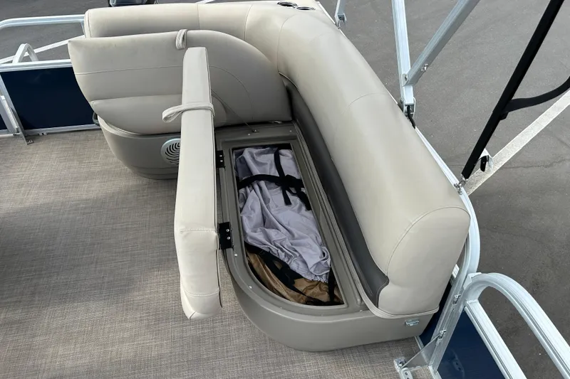 Slide: The Image of 2021 Sun Tracker Bass Buggy 16 XL boat seat storage compartment open, revealing interior space. - 14