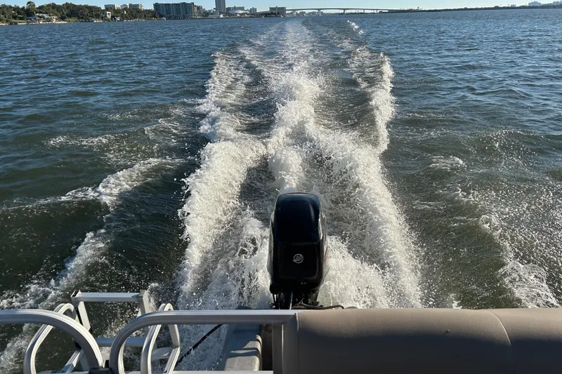 Slide: The Image of 2021 Sun Tracker Bass Buggy 16 XL cruising on open water, leaving a wake. - 18