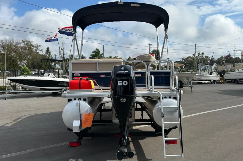 Slide: The Image of 2021 Sun Tracker Bass Buggy 16 XL pontoon boat with Mercury 50 engine, docked outdoors. - 3