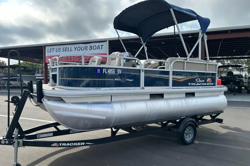 Slide: The Image of 2021 Sun Tracker Bass Buggy 16 XL pontoon boat on trailer at dealership. - 5