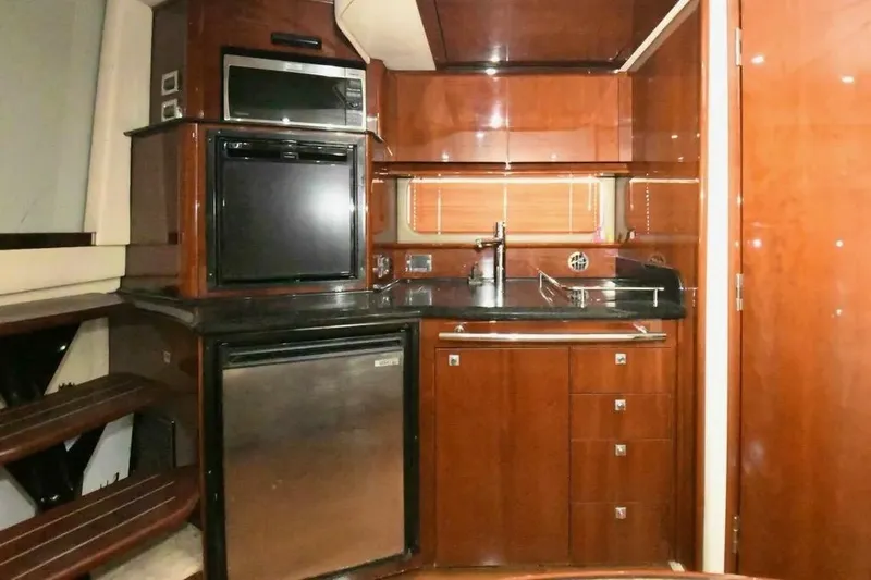 Slide: The Image of Luxurious 2010 Sea Ray 390 Sundancer yacht kitchen with modern appliances and wood cabinetry. - 10