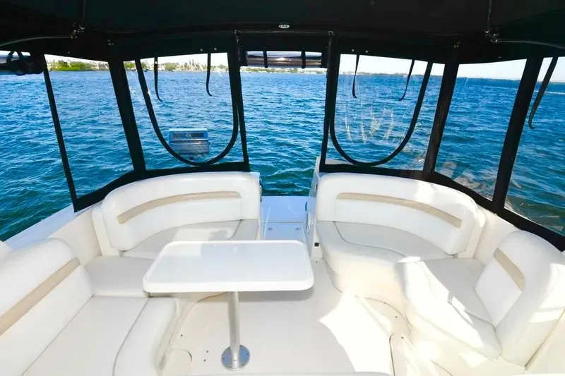 Slide: The Image of Luxurious 2010 Sea Ray 390 Sundancer yacht interior with white seating and ocean view. - 14