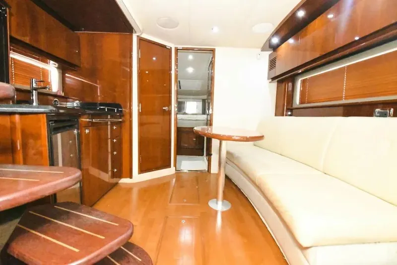 Slide: The Image of Luxurious interior of 2010 Sea Ray 390 Sundancer yacht with wood finishes and seating area. - 6