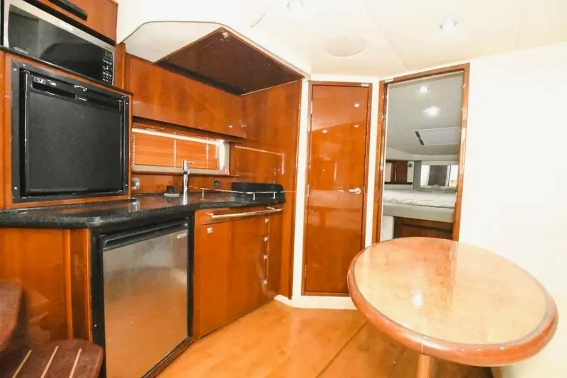 Slide: The Image of Luxurious interior of 2010 Sea Ray 390 Sundancer yacht with kitchenette and dining area. - 9