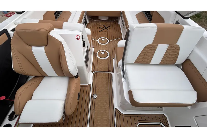 Slide: The Image of 2022 MasterCraft X26 interior with tan and white seating, featuring stylish design and premium materials. - 19