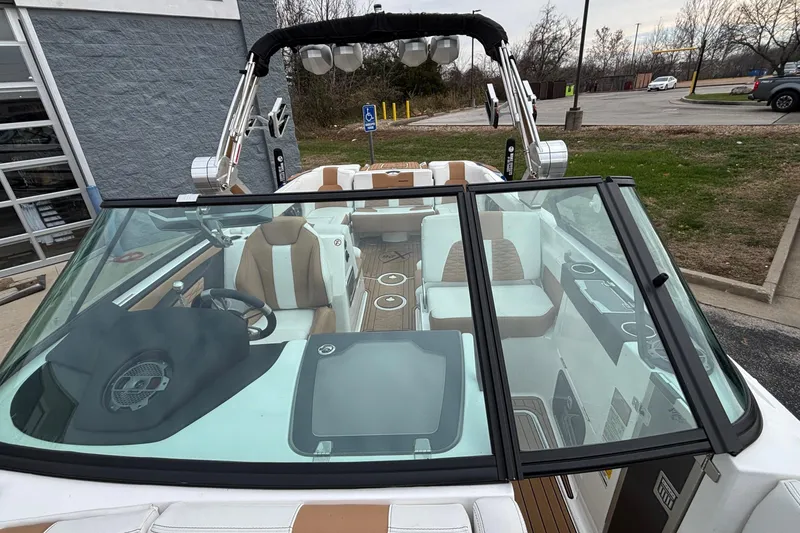 Slide: The Image of 2022 MasterCraft X26 boat interior with luxury seating and modern dashboard. - 20