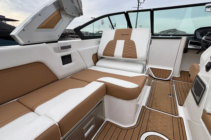 Slide: The Image of 2022 MasterCraft X26 boat interior with luxurious tan and white seating. - 29