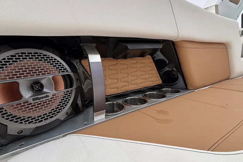 Slide: The Image of 2022 MasterCraft X26 boat interior with Klipsch speaker and cup holders. - 31