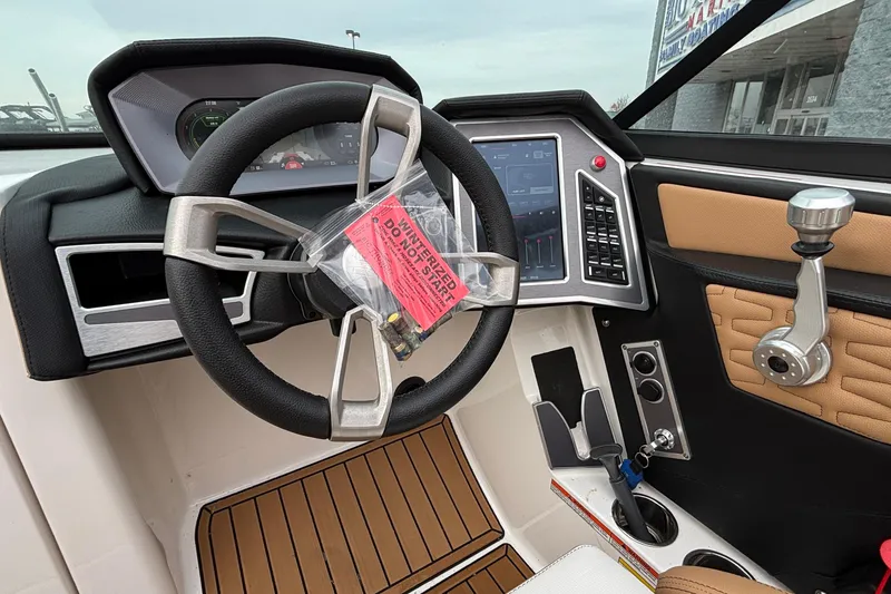 Slide: The Image of 2022 MasterCraft X26 boat dashboard with steering wheel and control panel. - 34