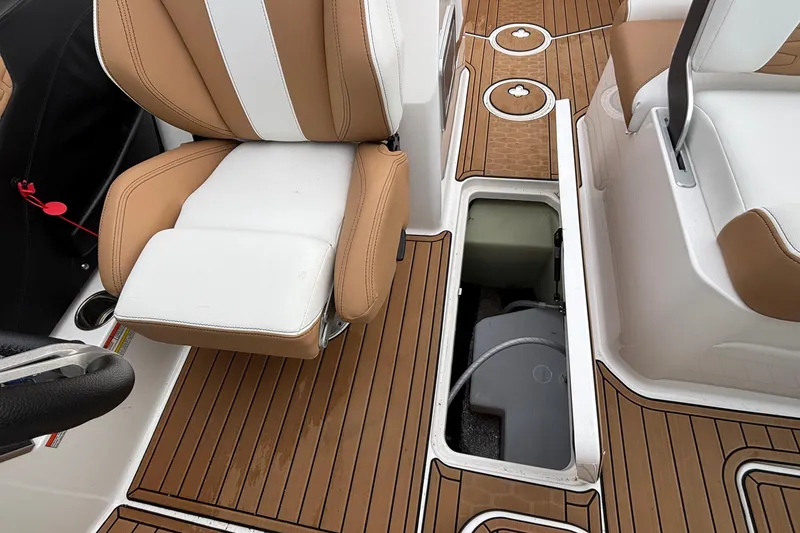 Slide: The Image of 2022 MasterCraft X26 interior with tan and white seating, open storage compartment. - 39