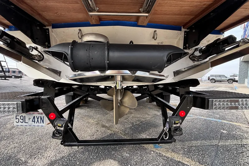 Slide: The Image of Rear view of 2022 MasterCraft X26 boat on trailer, showcasing propeller and exhaust system. - 4