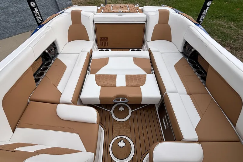 Slide: The Image of 2022 MasterCraft X26 boat interior with luxurious tan and white seating. - 42
