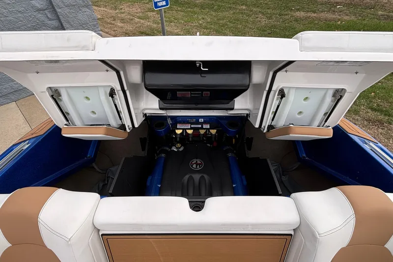 Slide: The Image of 2022 MasterCraft X26 boat engine compartment with open hatches, showcasing interior components. - 43