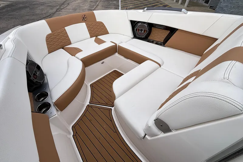 Slide: The Image of Luxurious interior of 2022 MasterCraft X26 boat with tan and white seating. - 51
