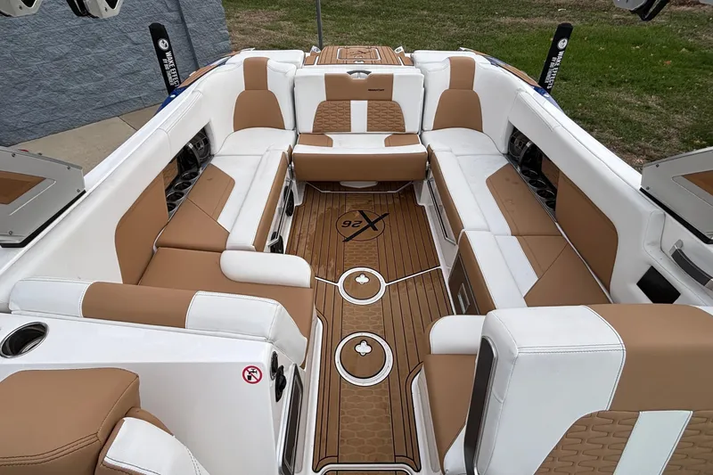Slide: The Image of 2022 MasterCraft X26 boat interior with luxurious tan and white seating. - 9