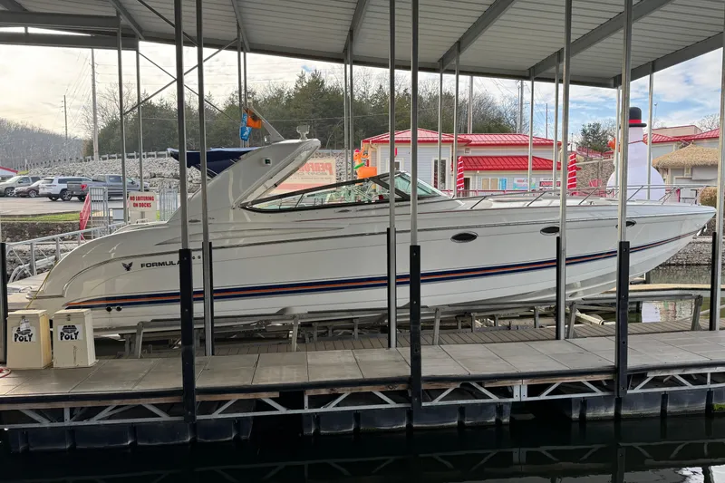 The Image of 2005 Formula 400 Super Sport boat docked under a covered marina. - 0