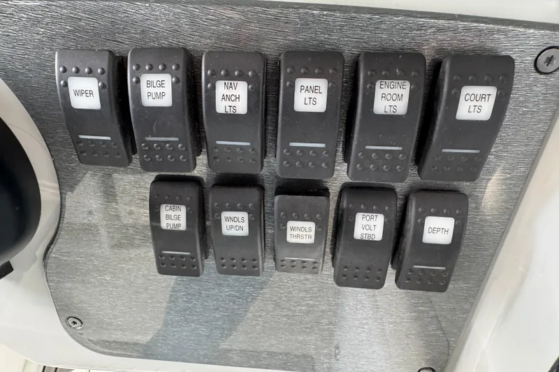 Slide: The Image of Control panel of a 2005 Formula 400 Super Sport boat with labeled switches. - 25