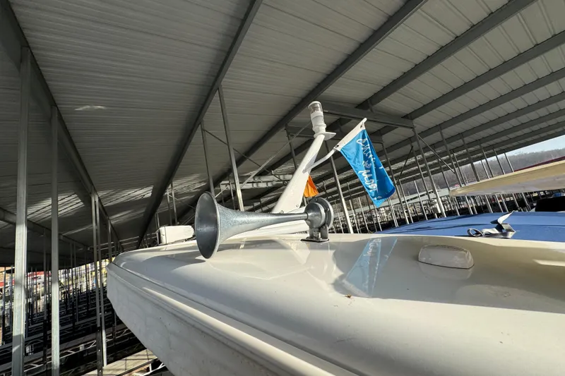 Slide: The Image of 2005 Formula 400 Super Sport boat docked under a metal canopy. - 32