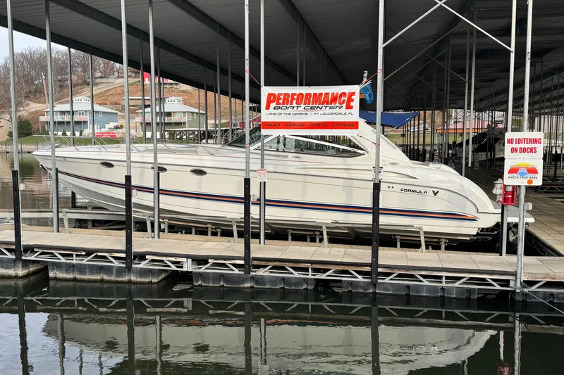 Slide: The Image of 2005 Formula 400 Super Sport boat docked at marina under covered slip. - 4