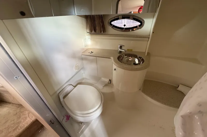 Slide: The Image of 2005 Formula 400 Super Sport yacht bathroom with toilet, sink, and porthole window. - 41