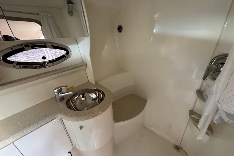 Slide: The Image of 2005 Formula 400 Super Sport yacht bathroom with sink, porthole, and shower area. - 43
