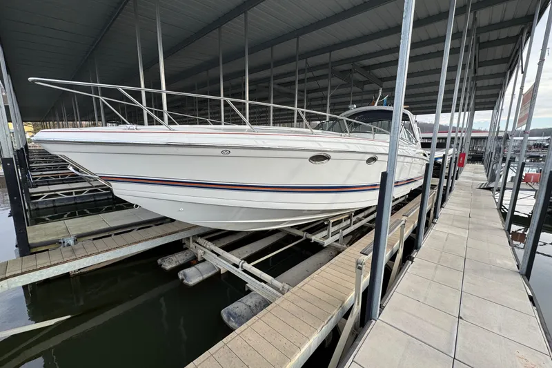 Slide: The Image of 2005 Formula 400 Super Sport boat docked in a covered marina. - 5