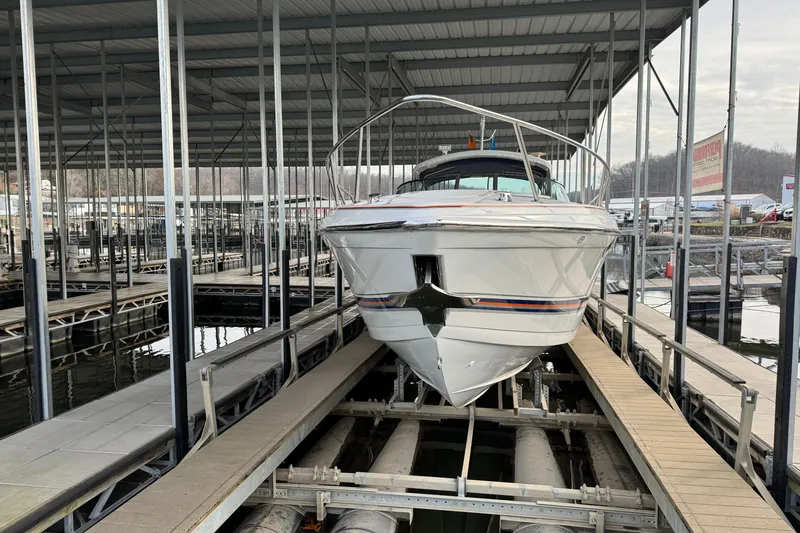 Slide: The Image of 2005 Formula 400 Super Sport boat docked in a covered marina. - 6