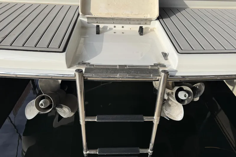 Slide: The Image of Rear view of a 2005 Formula 400 Super Sport boat with propellers and swim ladder. - 8