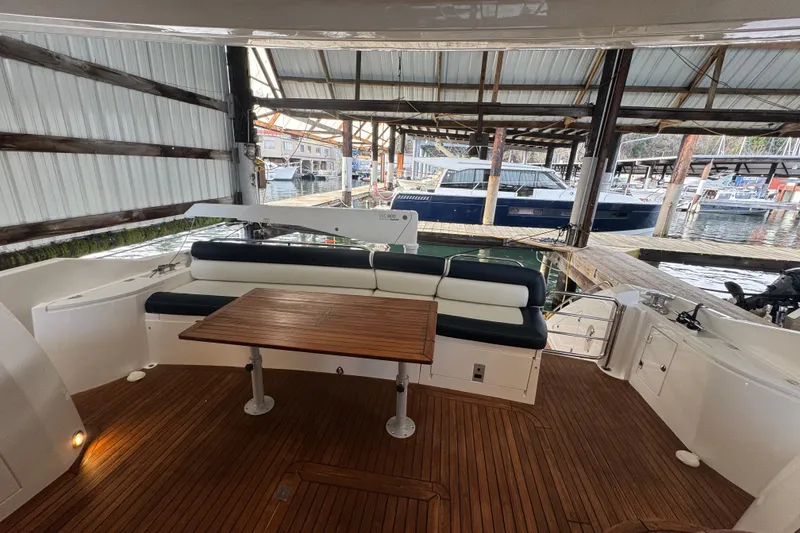 Slide: The Image of 2006 Sunseeker Manhattan 50 yacht interior with wooden deck and seating area. - 10