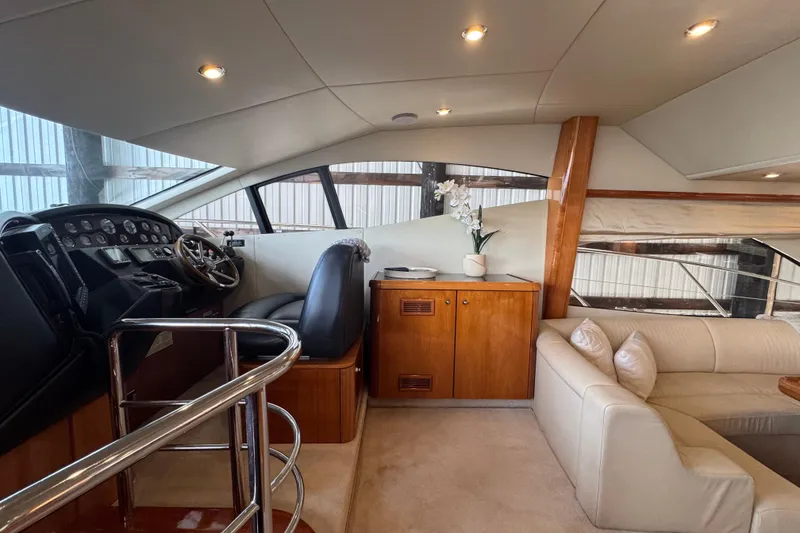 Slide: The Image of Luxurious interior of a 2006 Sunseeker Manhattan 50 yacht with helm and seating area. - 14