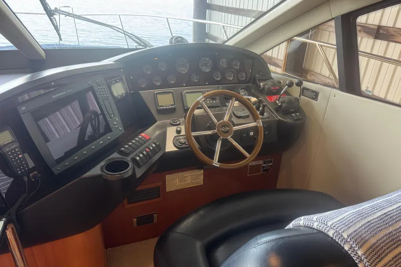 Slide: The Image of Helm of 2006 Sunseeker Manhattan 50 yacht with steering wheel and navigation controls. - 15