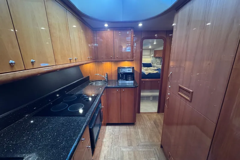 Slide: The Image of Luxurious kitchen interior of 2006 Sunseeker Manhattan 50 yacht with wood cabinetry and modern appliances. - 17