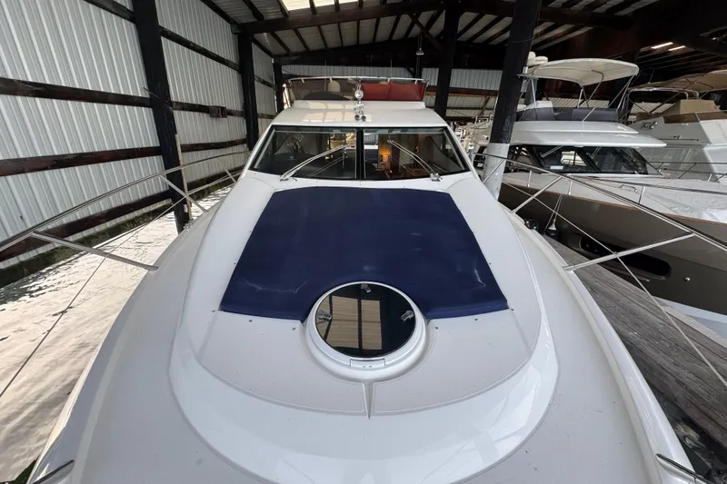 Slide: The Image of 2006 Sunseeker Manhattan 50 yacht docked in a covered marina. - 2